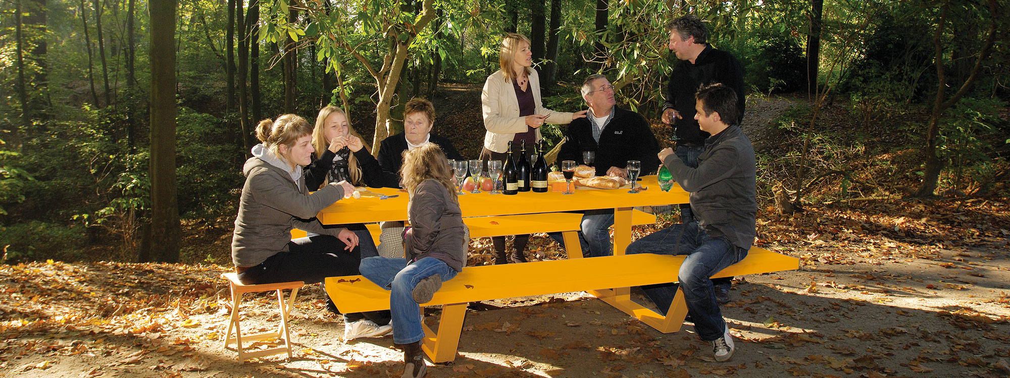 Famly Sat At Yellow Cassecroute MODERN Picnic Table & LUXURY PICNIC FURNITURE. SHORT Or LONG Picnic Table Sizes Up To 14m Made In High QUALITY Picnic Furniture Materials. Cassecroute DESIGNER Picnic FURNITURE Designed By Ronald Mattelé. CASSECROUTE Modern PICNIC Tables. DESGNER Picnic Table, LARGE Rectangular Picnic Tables, CIRCULAR Steel Picnic Tables In HIGH QUALITY Picnic FURNITURE Materials.