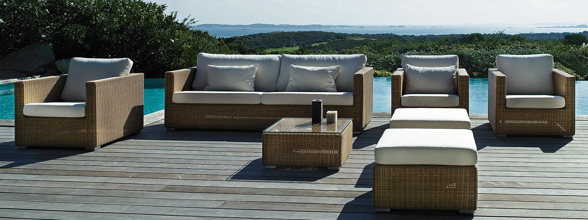 Image of natural rattan finish Chester garden sofa set on wooden decked poolside by Cane-line
