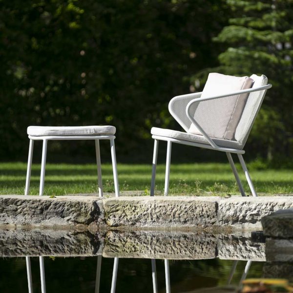 Image of Condor modern white garden chair and foot stool beside peaceful water feature