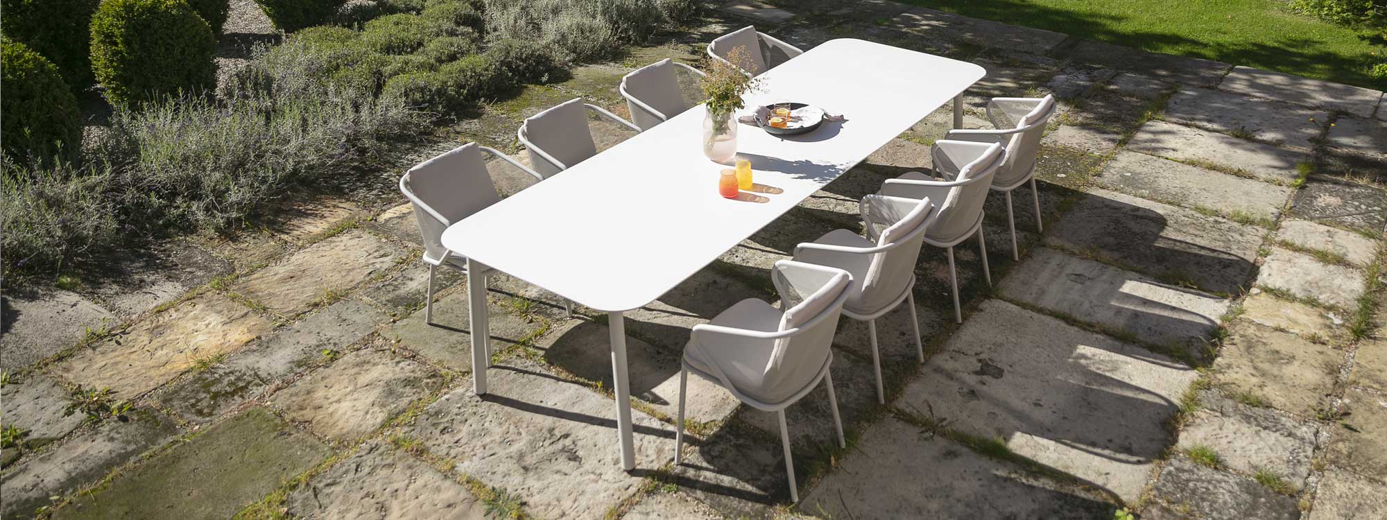 Image of birdseye view of Condor white garden dining set on rustic terrace