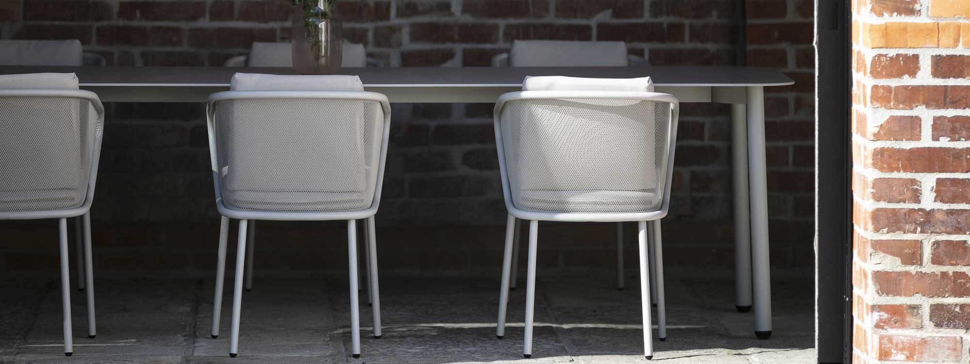 Image of detail of Condor garden chair's steel mesh back lends transparency to the furniture's design
