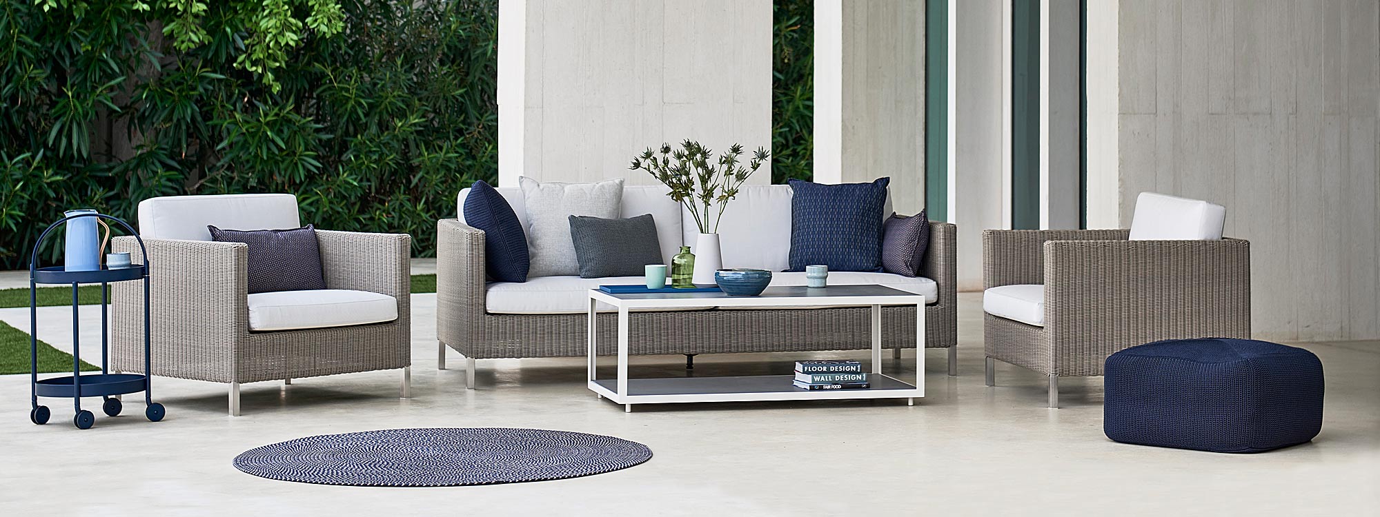 Image of Cane-line Connect 3 seat garden sofa and lounge chairs in taupe rattan weave with white cushions and white Level outdoor coffee tables