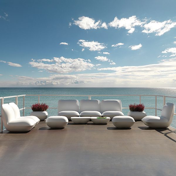 Image of large configuration of Pillow white contemporary outdoor lounge furniture with blue sea and sky in the background