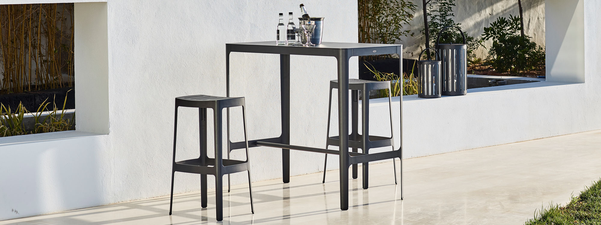 Black Cut modern outdoor bar furniture is a minimalist exterior bar set in all-weather furniture materials by Cane-line garden furniture company