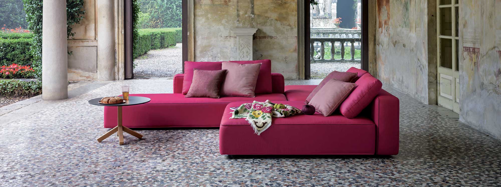 Image of Dandy pink garden sofa and daybed on mosaic floor within classical garden room