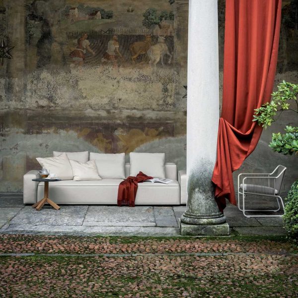 Image of Dandy white garden sofa and Harp lounge chair by RODA, on classical terrace with fresco painted on wall