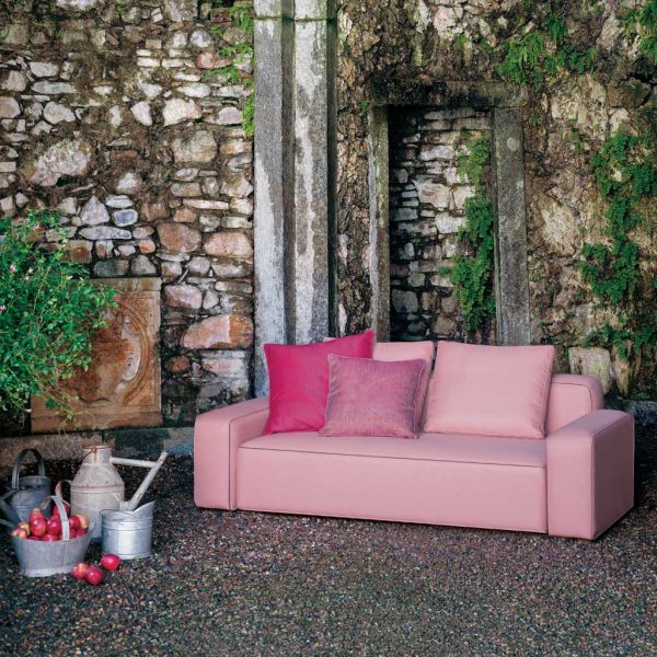 Dandy pink garden sofa shown on gravel