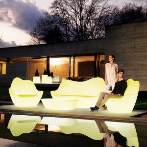 Night Time Shot Of Illuminated SABINAS Organic DESIGN Garden SOFAS Designed By Javier Mariscal. MODERN Outdoor LOUNGE Furniture & LED Lit Garden Furniture Collection Includes 3 Seat Sofa, Lounge Chair & Low Table, Made By VONDOM Designer Plastic GARDEN FURNITURE.