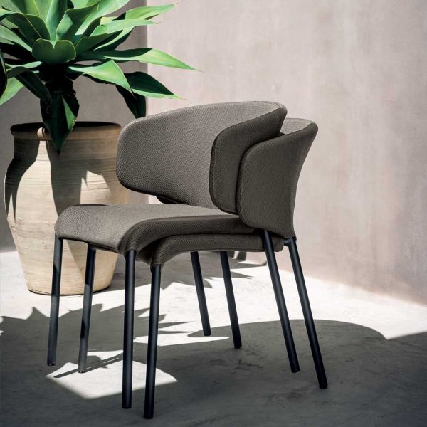 Image of pair of stacked Double upholstered garden chairs by RODA in light and shade on terrace
