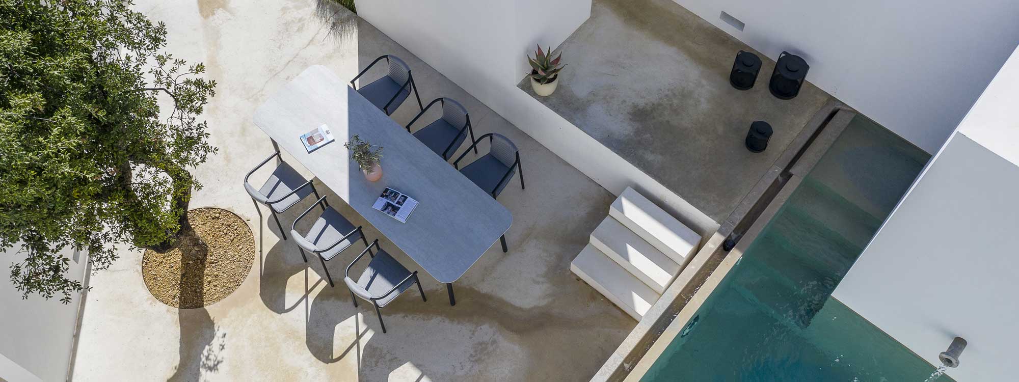 Birdseye view of Duct Round chair and Starling modern garden table on contemporary terrace