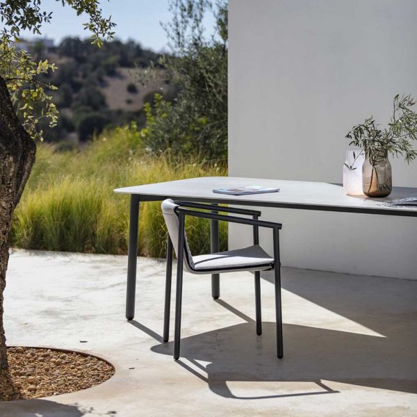 Image of Todus Duct Round modern garden chair and Starling rectangular garden table in sunny whitewashed courtyard