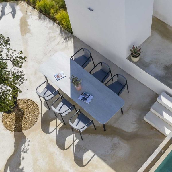 Image of aerial view of Todus Duct modern garden chair and Starling modern outdoor table in light and shade of whitewashed Portuguese courtyard