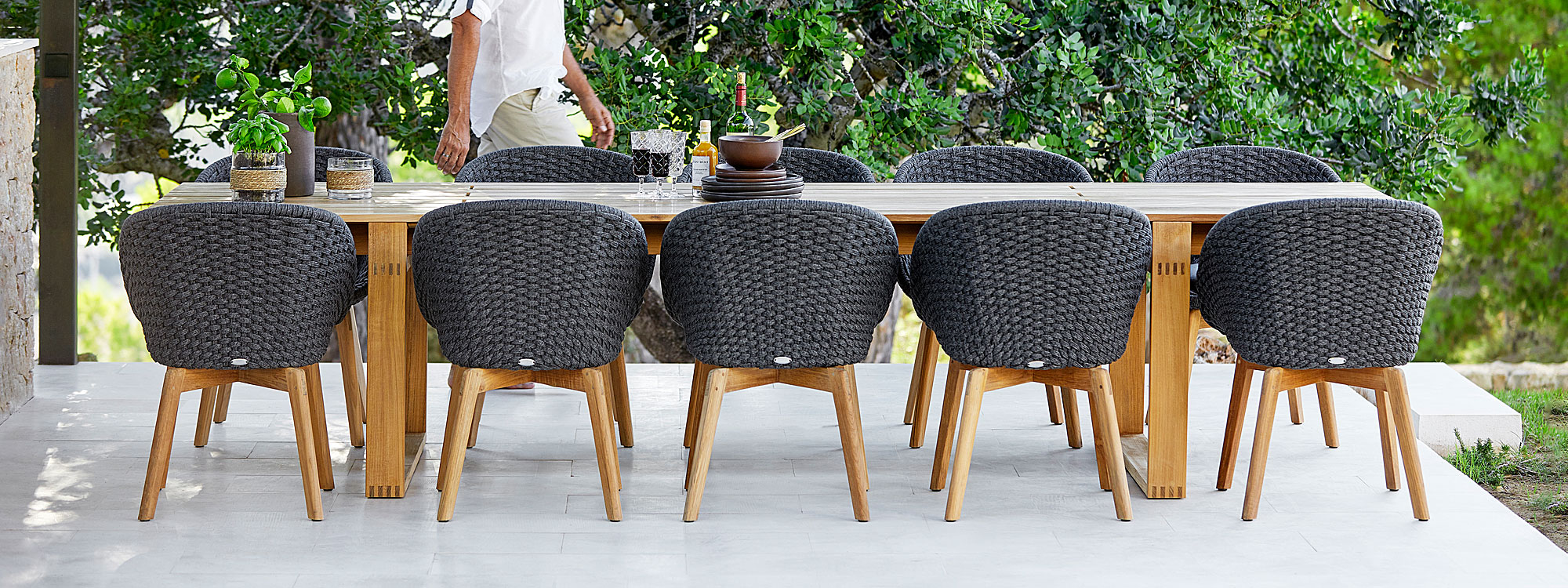 Image of Endless large teak table and 10 Peacock dining chairs in dark-grey Sort Rope and teak by Cane-line