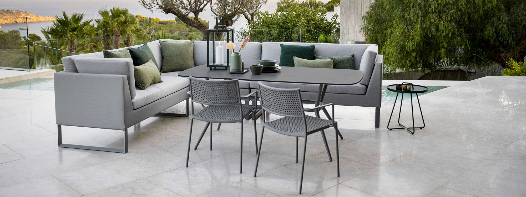 Image of Flex corner dining sofa, Joy ceramic garden table and Less outdoor dining chairs by Cane-line