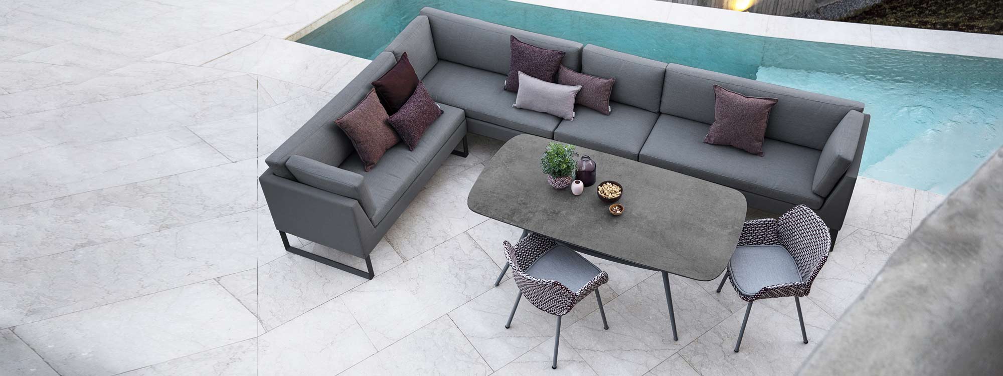 Image of aerial view of Flex garden dining sofa, Joy outdoor table and Vibe rattan chairs by Cane-line