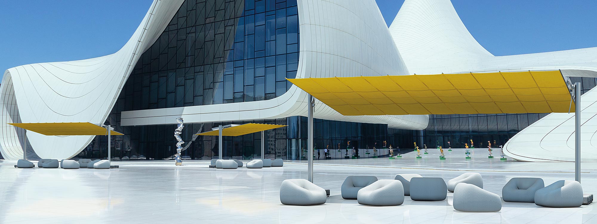 Image of FIM Flexy Large free-standing awnings with yellow canopies in front of large modernist building