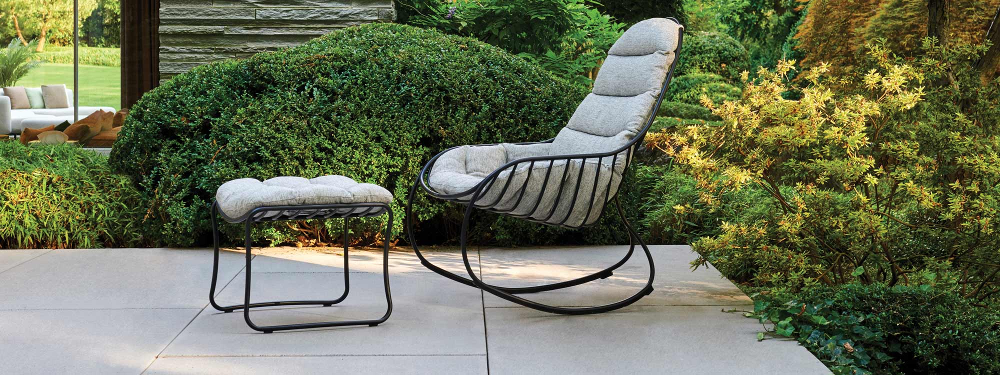 Image of anthracite-coloured Folia outdoor rocking chair and foot stool with grey cushions by Royal Botania