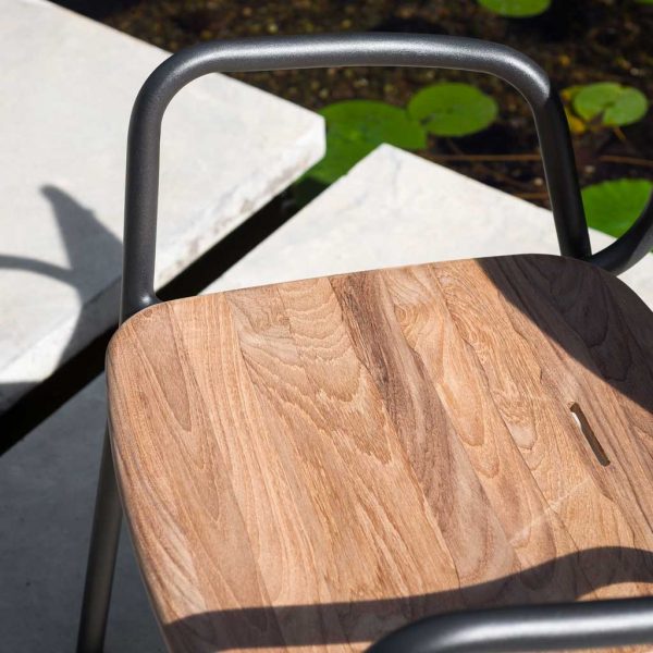 Image of detail of teak seat tablet & tubular aluminum frame of RODA Guest stacking garden chair