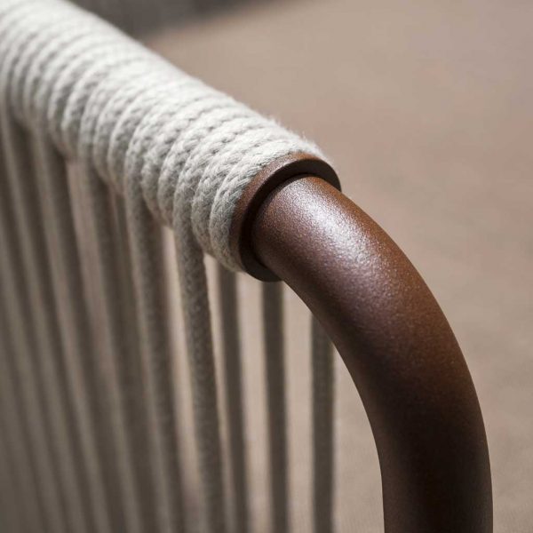 Image of detail of rust-coloured stainless steel tubular frame with Sand polypropylene rope of Harp chair by RODA