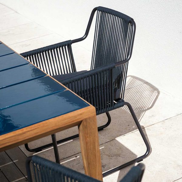 Image of Harp blue garden chair and Teka outdoor dining table in teak with blue glazed ceramic top by RODA
