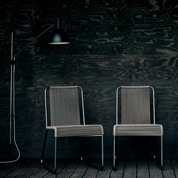 Image of pair of black Harp garden chairs on black decking