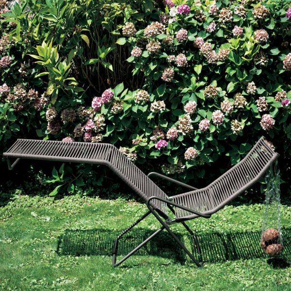 Harp outdoor recliner chair on grassy lawn, designed by Rodolfo Dordoni