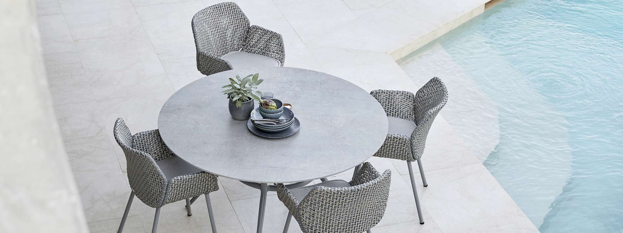 Image of birds eye view of Joy round garden table and Vibe armchairs by Cane-line