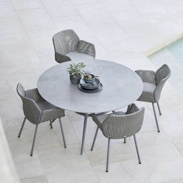 Image of birds eye view of Cane-line Vibe rattan armchairs around Joy round garden dining table