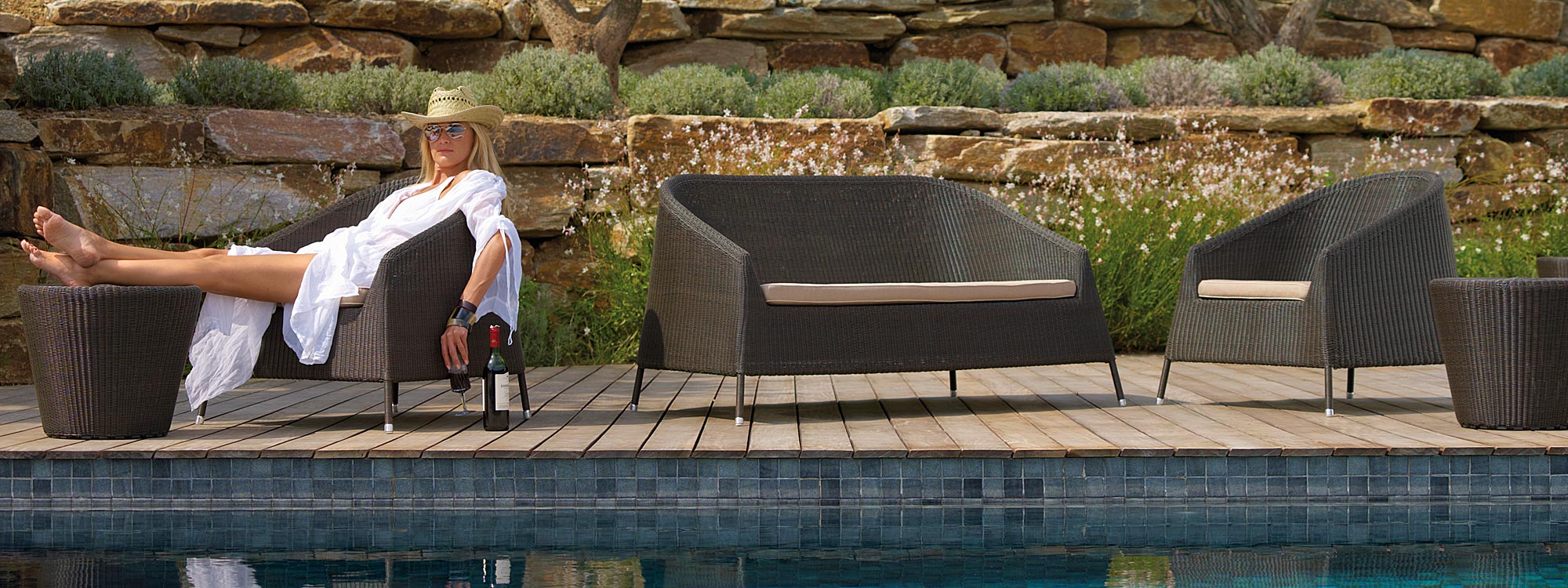 Kingston all-weather wicker lounge furniture includes a modern outdoor rattan sofa & lounge chairs by Cane-line luxury garden furniture.