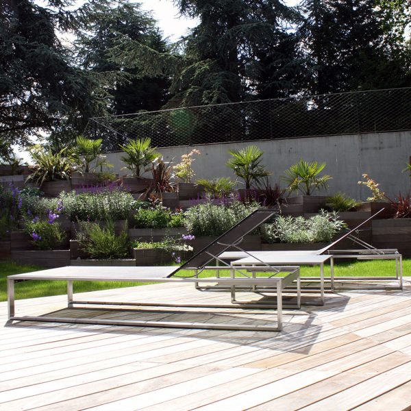 Image of pair of Siesta linear sun loungers on sunny wooden decking