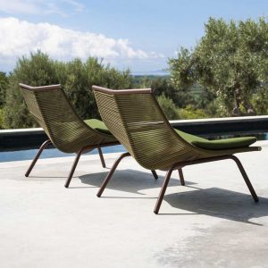 Image from back of pair of RODA Laze garden relax chairs with rust-colored tubular frame and olive colored acrylic cod seat and back, shown on sunny poolside