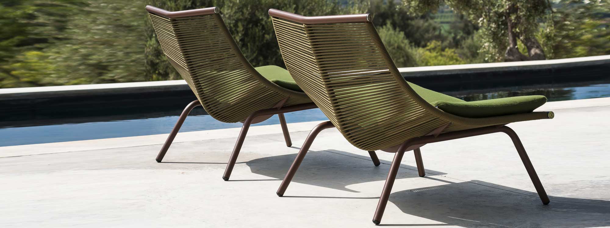 Pair of Laze modern garden chairs by swimming pool