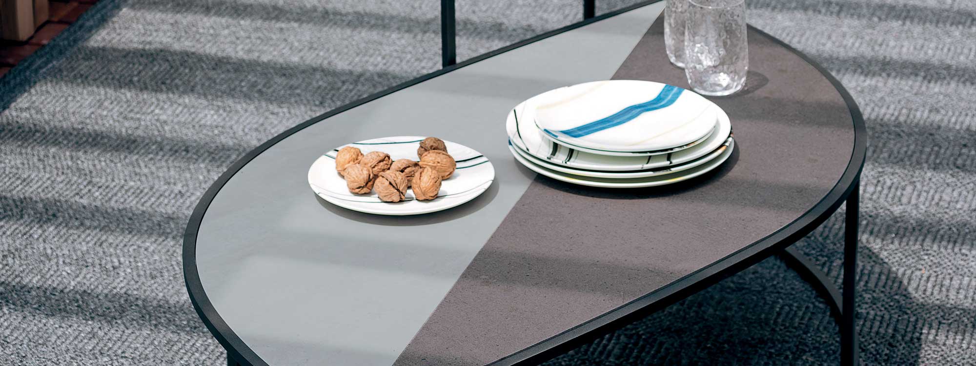 Image of RODA Leaf minimalist outdoor low table with plate of walnuts and glasses on top