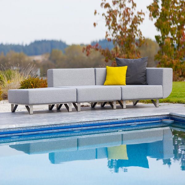 Image of Lotus grey garden sofa from across a swimming pool