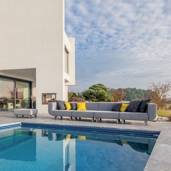 Image of Lotos large outdoor sofa taken from the other side of a swimming pool