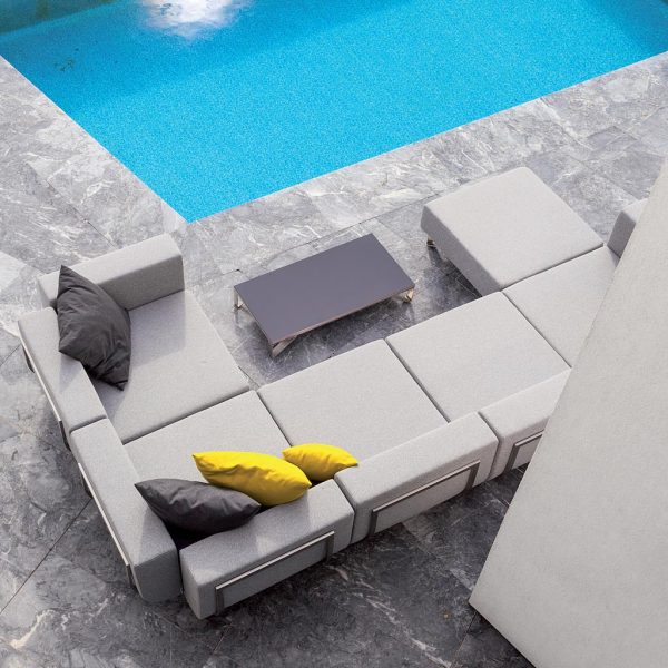 Image of aerial view of Lotos exterior corner sofa and ottoman with grey cushions, shown on poolside
