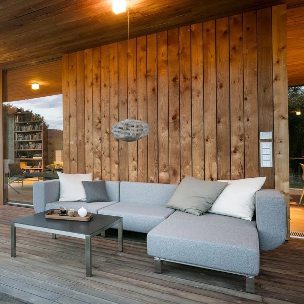 Image of Lotos garden sofa and ottoman on wooden decking of veranda