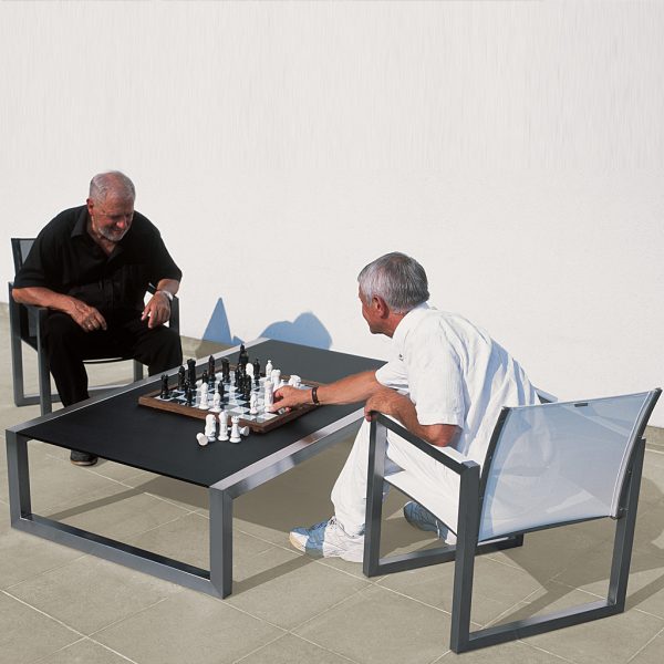 Image of couple of old men playing chess on black and white Ninix furniture by Royal Botania