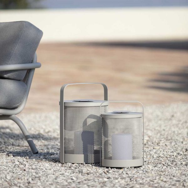 Grey-Silk coloured Luci LED outdoor lanterns on gravel next to Starling modern garden lounge chair by Todus