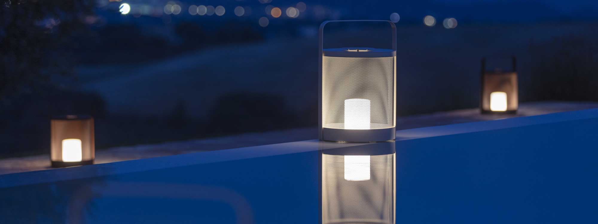 Luci portable garden lights around swimming pool at nighttime