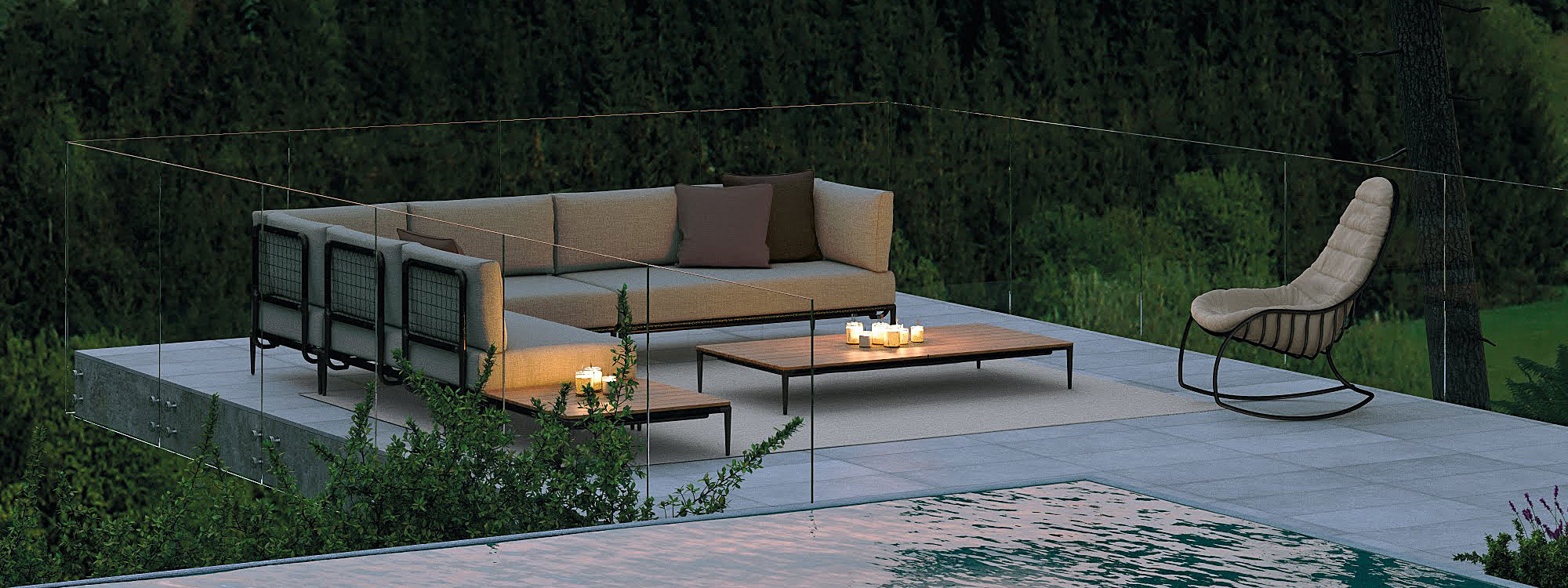 Nighttime image of Folia rocking chair and Lusit garden sofa on terrace by Royal Botania