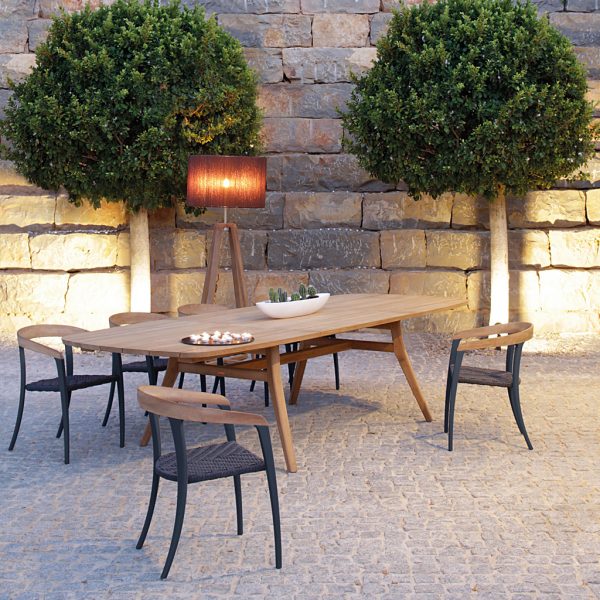 Image of Jive Zidiz outdoor dining furniture by Royal Botania in courtyard at dusk