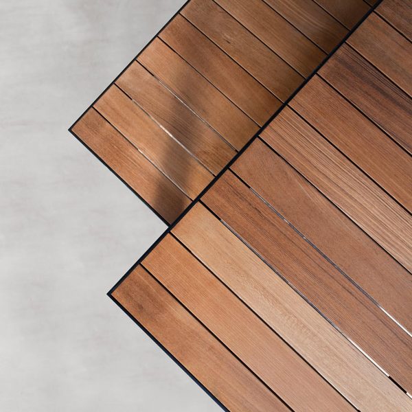Image of aerial view of detail of teak surfaces of Garden Dinner table and bench by Roshults