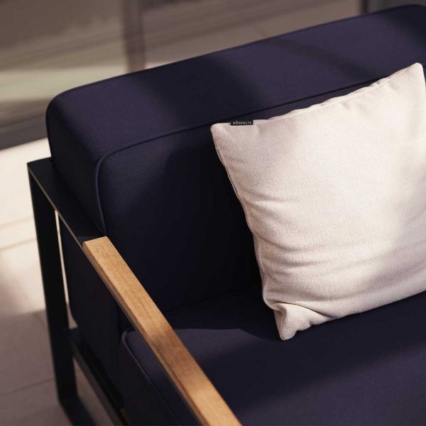 Image of detail of teak armrest and Navy Blue cushions from Moore modern garden sofa by Roshults