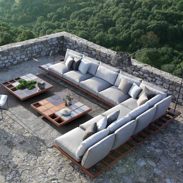 Mozaix mahogany sofa with grey cushions by Royal Botania