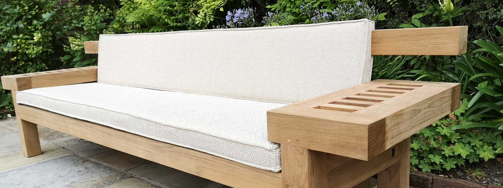 Image of Royal Botania Nara teak garden bench with back and seat cushions
