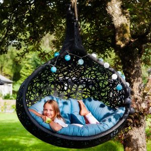 Girl relaxing in Bios Nest modern swing seat