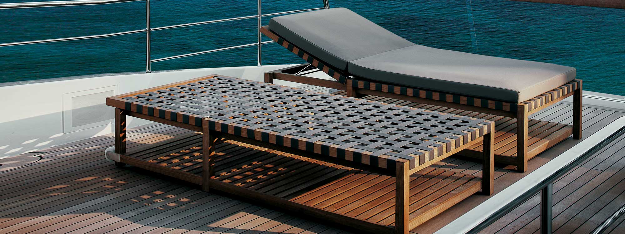 Pair of Network teak sunbeds with Brown webbing and Brown cushion on deck of superyacht