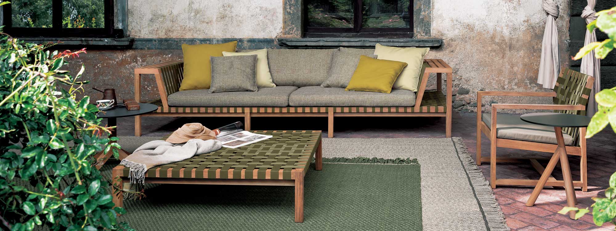 Network teak garden sofa with Olive webbing on outdoor terrace