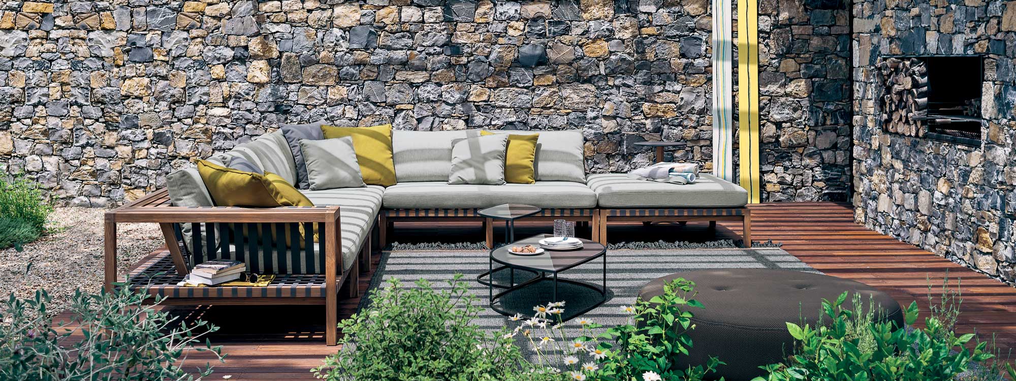 Network teak corner sofa and leaf outdoor low tables on patio